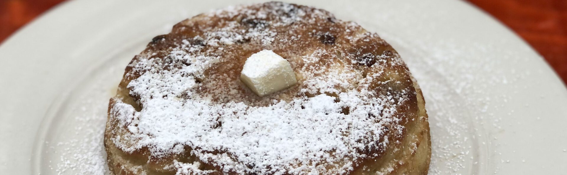 A close up of powdered sugar on top of a cake.