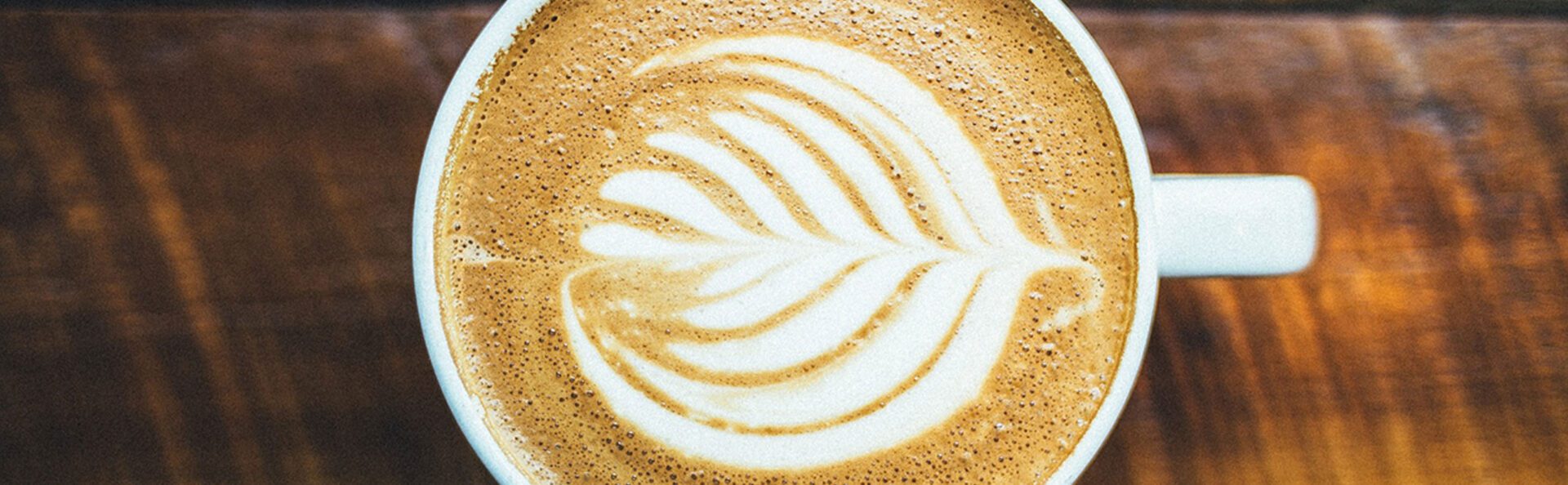 A close up of the coffee art on top of a cup.